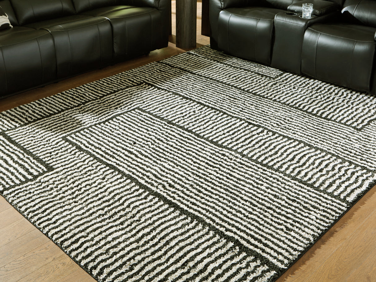 Furniture City Slidell - Ashley Furniture - Kurtmen Rug - 7'10" x 9'10" Area Rug / Black/Ivory - R407591